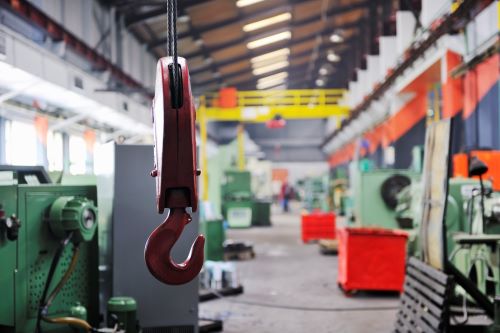 Large factory with a pulley in the foreground