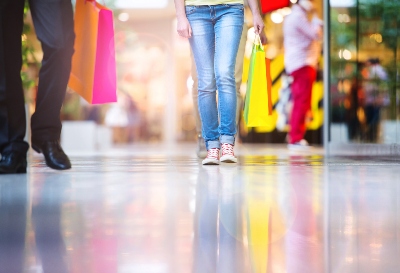 young-couple-with-bags-in-shopping-mall